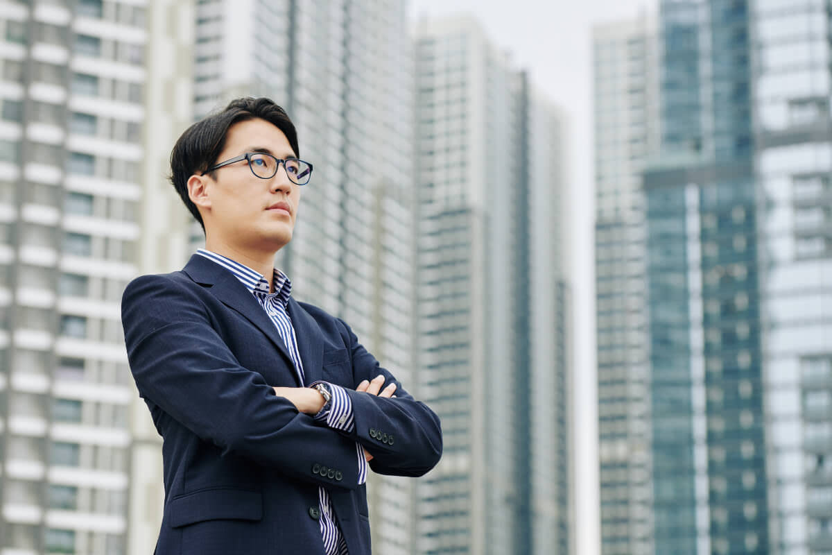 Investor Standing In Front of New Buildings